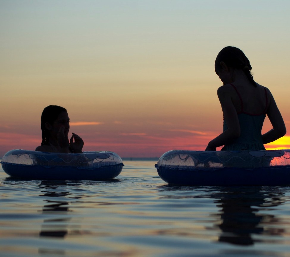 couple relaxing in the pool at dusk